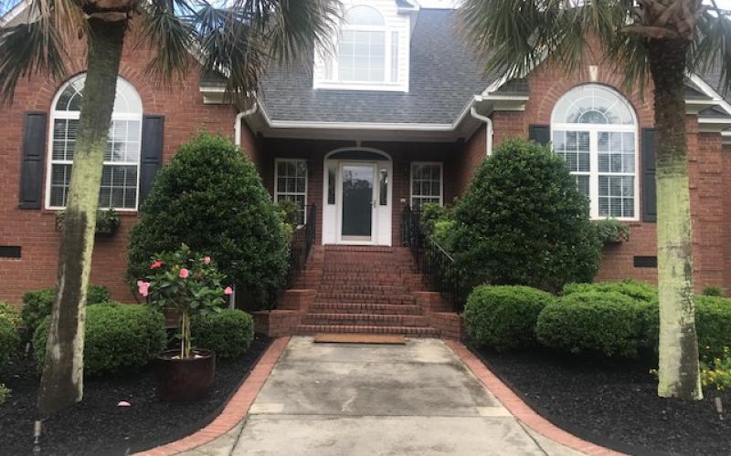 Black Rubber Mulch Landscaping Around Brick House
